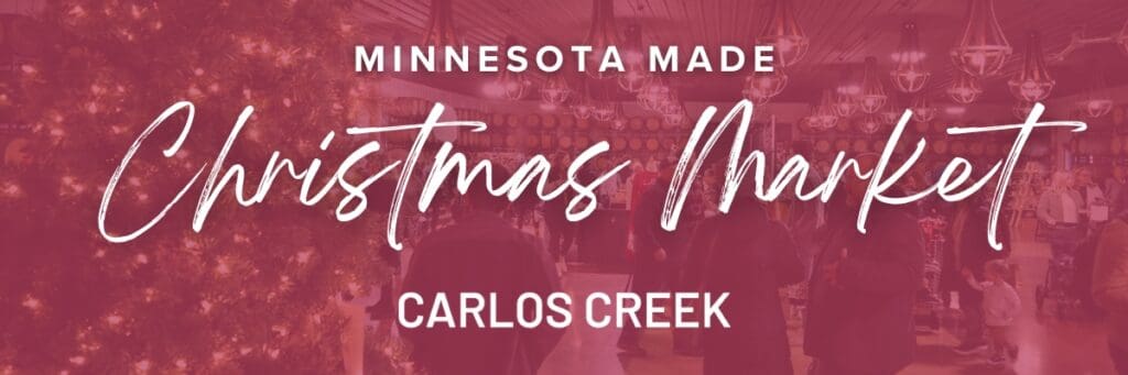A festive indoor Christmas Market with a decorated tree, people shopping, and the text “MN Made Christmas Market, Carlos Creek” overlaid in large, stylish lettering.
