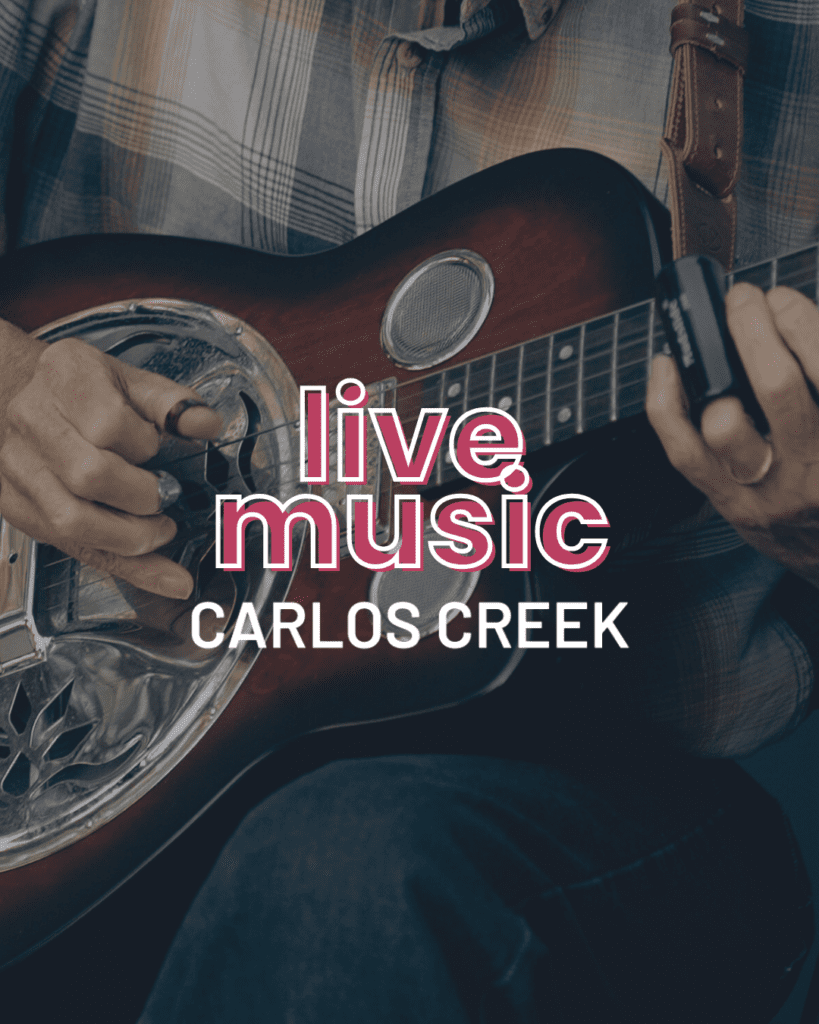 Close-up of a person playing a resonator guitar in a plaid shirt. Bold white and pink text reads "Live Music CARLOS CREEK," capturing the vibe of a Saturday afternoon filled with great tunes.