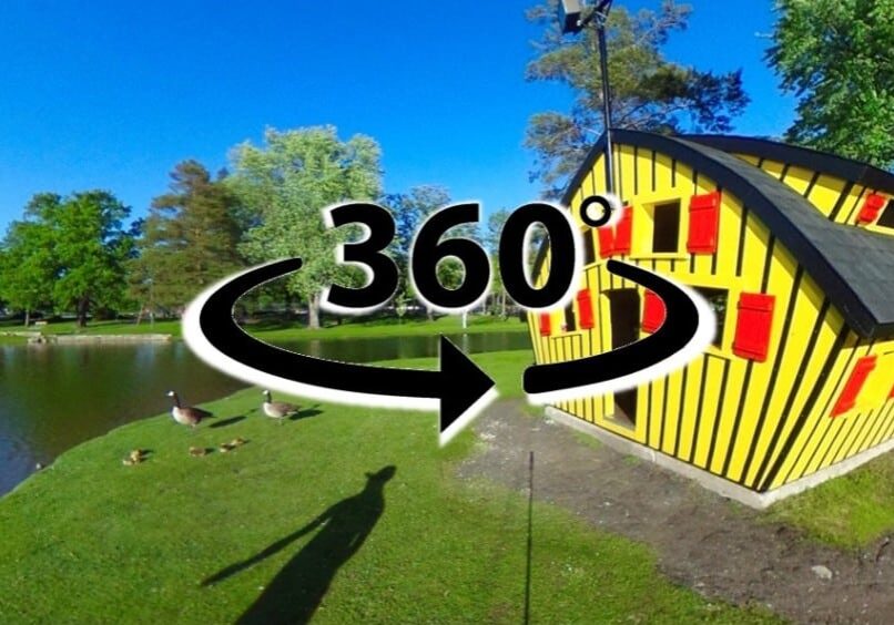A vibrant yellow house with red shutters stands near a pond, surrounded by green grass, trees, and geese. A large “360°” symbol invites you to tale a 360 virtual tour of the Alexandria Lakes Area—discover more with Alexandria MN tourism.