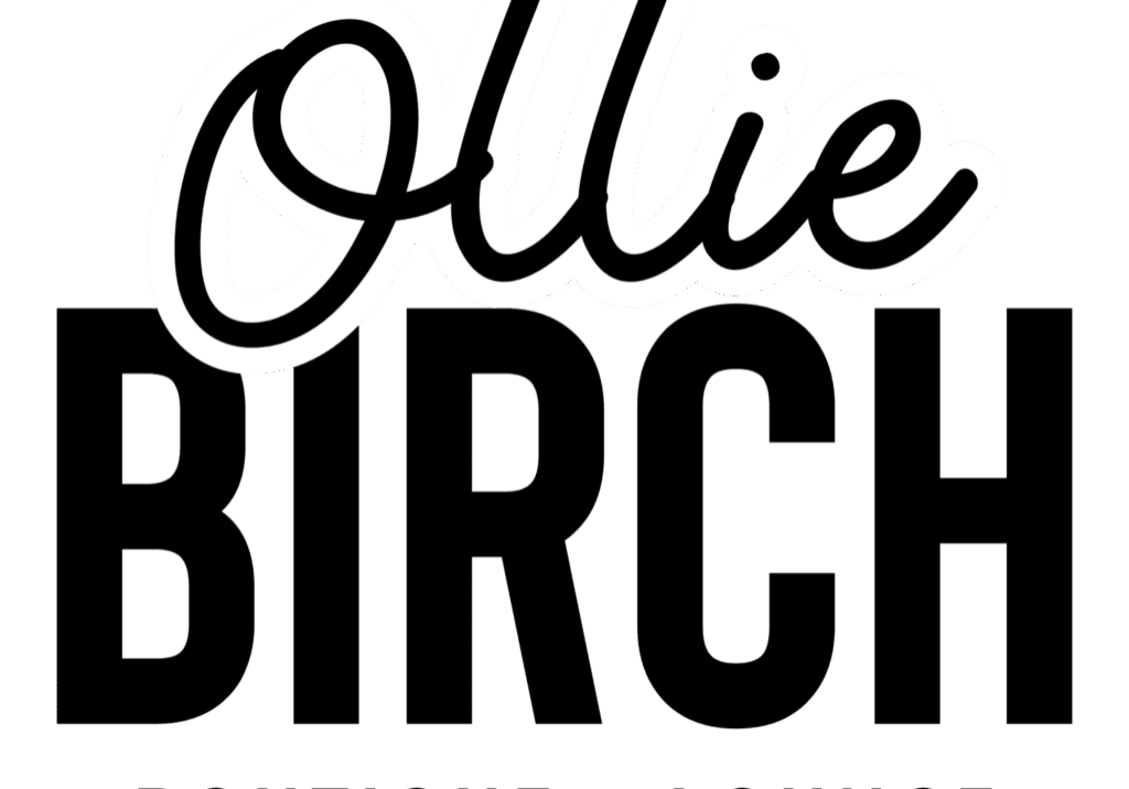 The word "Ollie" is written in bold, white, cursive letters with a black outline on a transparent background, capturing the chic and modern vibe of Ollie Birch Boutique + Lounge.
