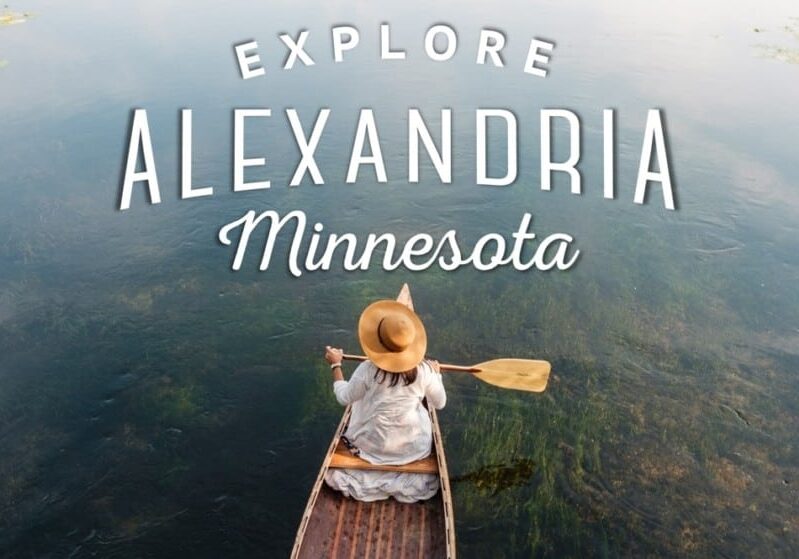 A person in a hat paddles a canoe on a calm lake, seen from above, with the text "Explore Alexandria Minnesota—must do summer activities in the lakes area" overlaid on the image.